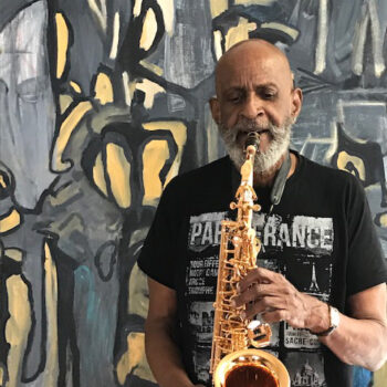 Claude Lawrence playing his saxophone (via BOMB Magazine)